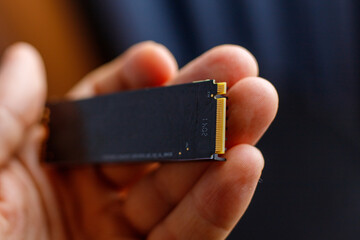 M.2 SSD drive. engineer person hold hardware device to upgrade desktop or laptop. Close up. Selective focus