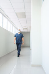 Fototapeta premium Doctor walking trough a hospital hall
