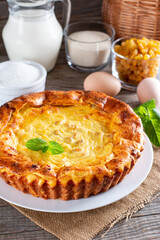 Cheese casserole with raisins on plate on wooden table