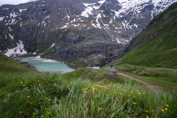 Solitary chapel near the emerald green Margaritze stausee lake on the Grossglockner High Alpine Road