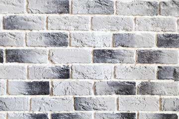 Brick grey wall with light and dark bricks