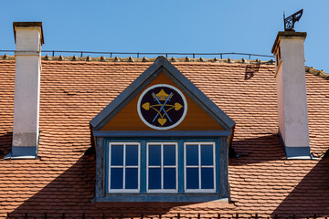 A roof with windows and chimney