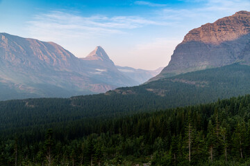 Sunrise along the Iceberg Lake trail in Glacier National Park Montana. Haze and smoke in the air from wildfires