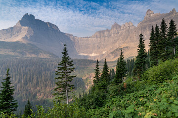 Sunrise along the Iceberg Lake trail in Glacier National Park Montana. Haze and smoke in the air from wildfires