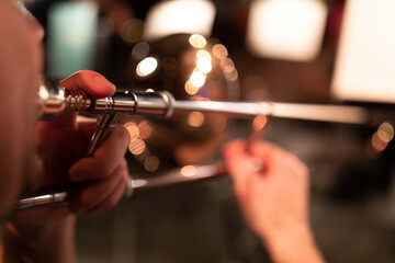 A person playing a trombone in stage lights