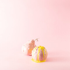 Christmas pumpkins on a light background. Soft and powdery composition. Pink and bright yellow. Liquid color.