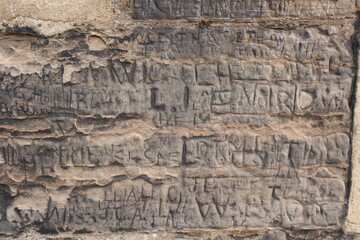 Ancient castle wall bricks with inscribed old writing