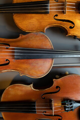 A top down view of multiple violins or violas that are common instrument of a classical orchestra