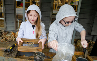 Children sifting for rocks at a gem mine
