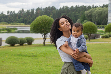 Young beautiful mother holds her baby in a hands