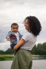 Young beautiful mother holds her baby in a hands
