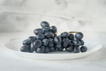 black grapes on a plate