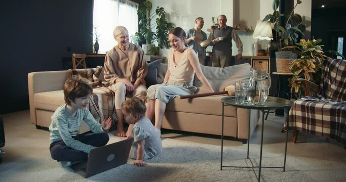 Three generation family with senior old grandparents, mom and dad, teenage boy and baby girl spend bonding time at home.