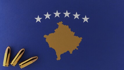 Three 9mm bullets in the bottom left corner on top of the national flag of Kosovo