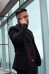 business man working from his phone wearing fashion office clothes