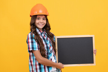 happy workers day. cheerful teen girl laborer hold blackboard. child advertising