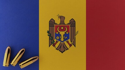 Three 9mm bullets in the bottom left corner on top of the national flag of Moldova