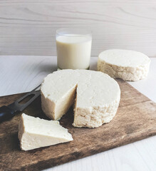 food derived from milk on white cheese on wooden background and with space for text