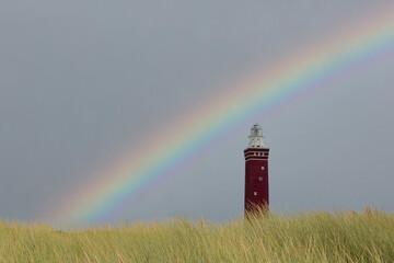 Westhoofd lighthouse in Ouddorp with beach grass  and rainbow