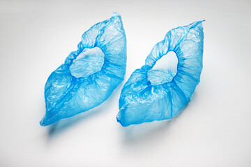 Disposable blue shoe covers on white background