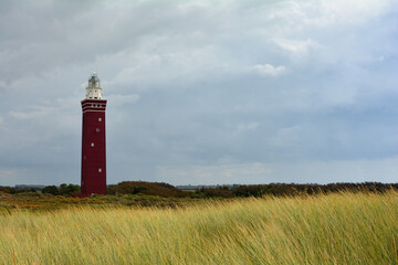 Westhoofd lighthouse on the left,  in Ouddorp in the Netherlands, in a green landscape