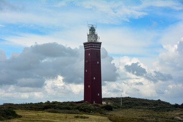 Westhoofd lighthouse in Ouddorp in the Netherlands, in a green landscape and sky
