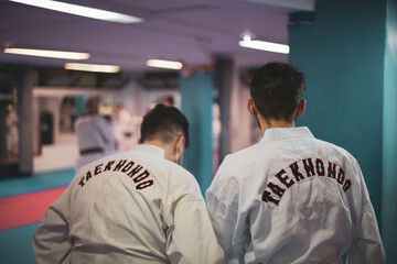 two boys in a kimono of
taekwondo enter a tatami