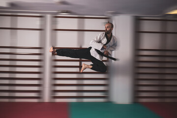 a teacher of
taekwondo kicking the air.