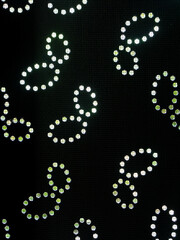 Abstract Flower Pattern on Black Metal Sheets Close-Up