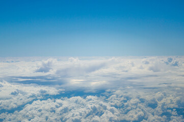 Fototapeta na wymiar Cloudy sky during the flight on the plane