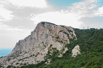 Beautiful view on mountain in front of blue sky with clouds