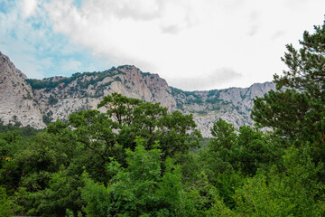 Beautiful low angle view on mountain in front of blue sky with clouds