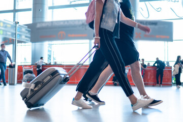 Fototapeta premium people wearing medical masks walking with luggage bags suitcases at the airport travel concept. High quality photo