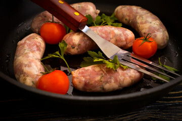 raw sausages, tomato on wooden background