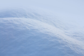 Fresh snow texture background in blue tone and sunlight.