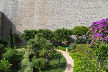 Garden and terrace design and landscaping: Lush mediterranean garden in front of an ancient virgin...