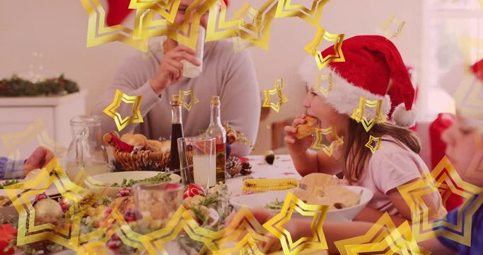 Animation of gold stars over caucasian daughter and father in santa hats eating christmas meal