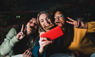 Multiracial friends having fun doing selfie with mobile phone at pizza bar restaurant outdoor -...