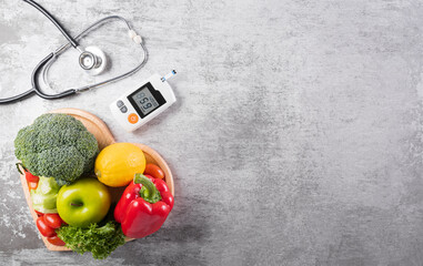 World diabetes day and healthcare concept. Healthy food eating nutrition in plate, stethoscope and diabetic measurement test set on stone background..
