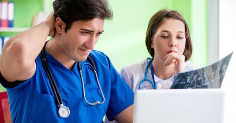 Woman and man gynecologists discussing medical case at the clini