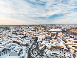 Beautiful Vilnius city panorama in winter with snow covered houses, churches and streets. Aerial view. Winter city scenery in Vilnius, Lithuania.