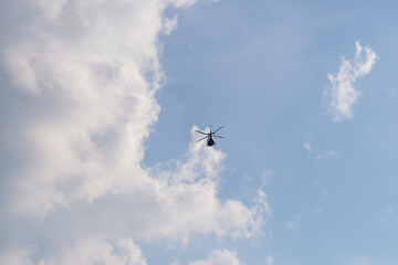 Naklejka na ściany i meble Airplane flying in the sky, On the azure sky, a helicopter flies.