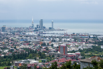 ariel panoramic view of old city and skyscrapers with the sea from the mountains