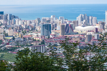 ariel panoramic view of old city and skyscrapers with the sea from the mountains