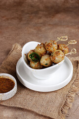Cilok is West Java Indonesia traditional snack made from tapioca flour, served with peanuts sauce.