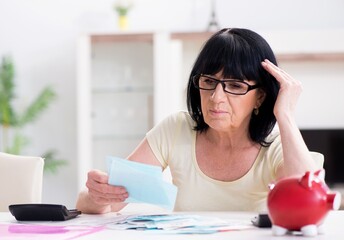 Mature woman trying to reconcile her bills