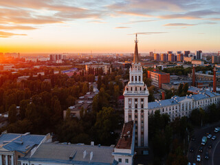 Evening summer Voronezh cityscape. Tower in architecture Stalinist empire at crimson sunset