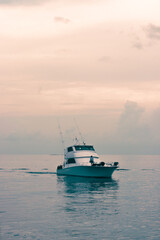 Yacht on the Caribbean Sea during sunset in Jamaica.