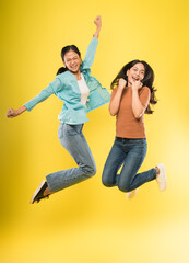 two happy women jumping and laughing happily