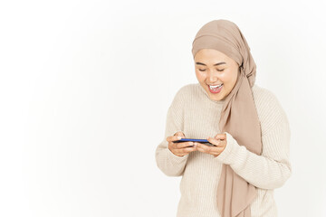 Playing game on smartphone of Beautiful Asian Woman Wearing Hijab Isolated On White Background